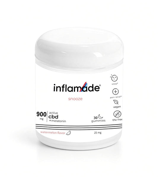 A white glass jar of inflamade 'snooze' watermelon flavor sleep gummies, featuring a clean white label with black and red text and icons, set against a plain white background.